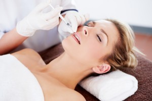 beautiful woman having botox injection in her lips